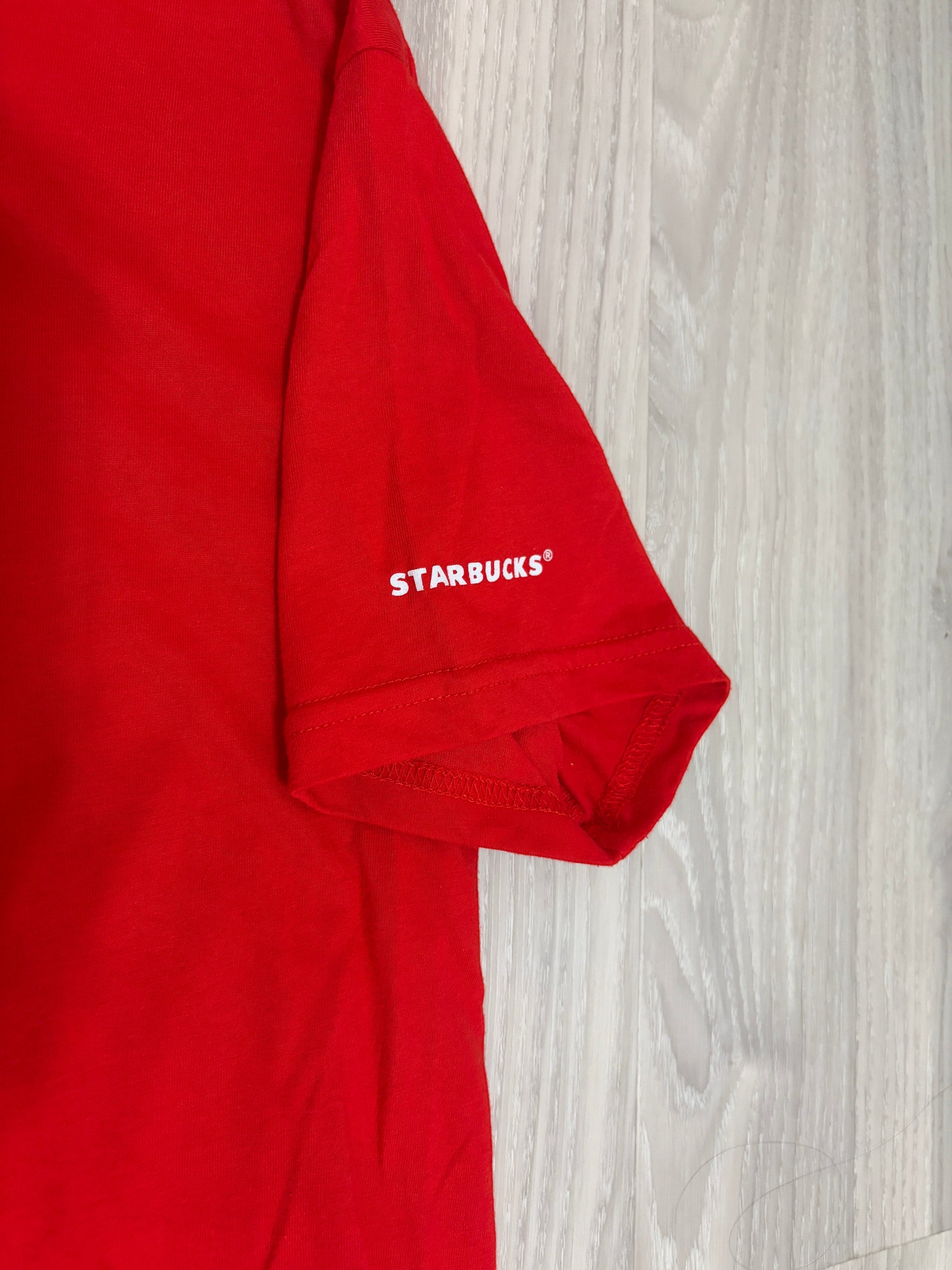 Leox Hub Starbucks Japan 2024 holiday staff t-shirt in red cotton with white logo detail on the sleeveLeox Hub Starbucks Japan 2024 Holiday staff t-shirt